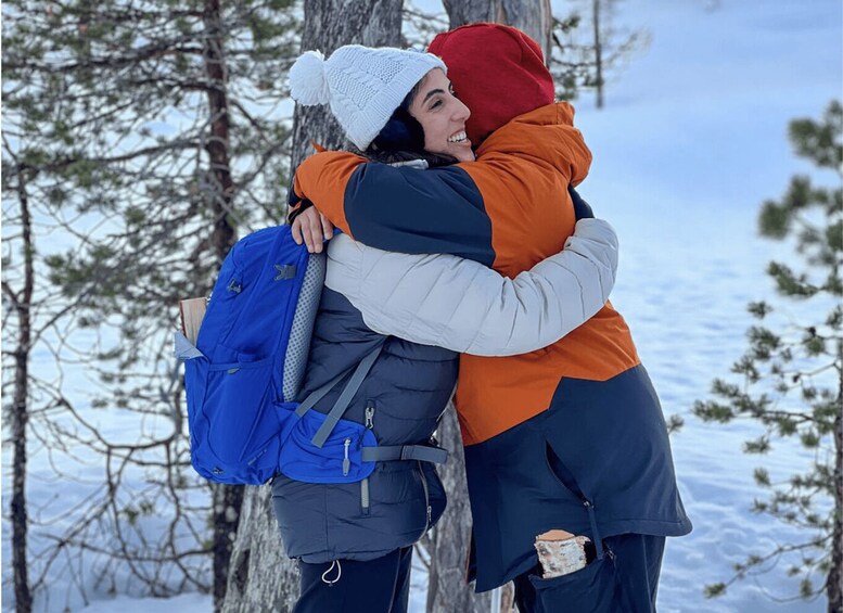 Two people hugging in a snowy forest. 5