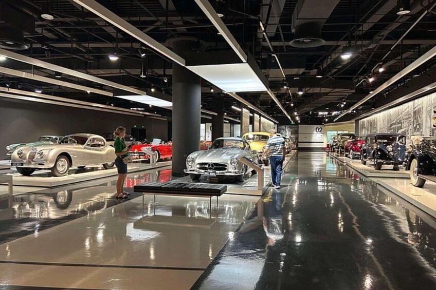 A car exhibition with vintage and modern vehicles on display. 2