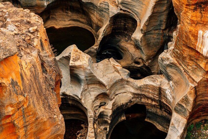 A canyon with layered rock formations and deep crevices. 4