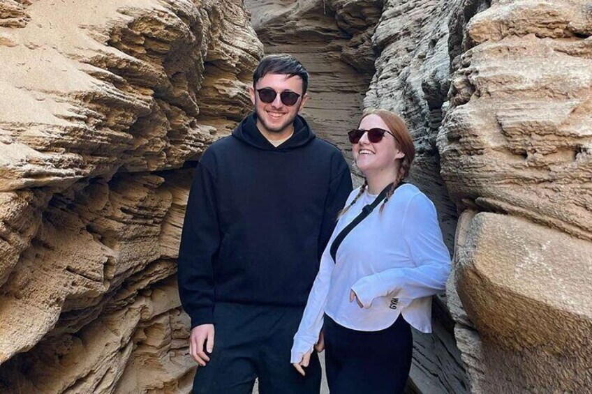 Two people standing in a rocky canyon. 5