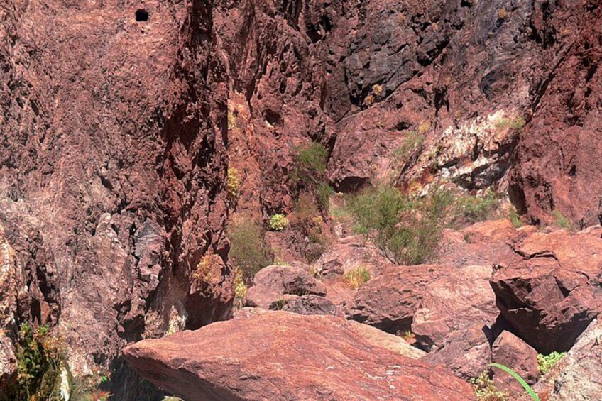 A rugged rocky landscape with large boulders and sparse vegetation. 5