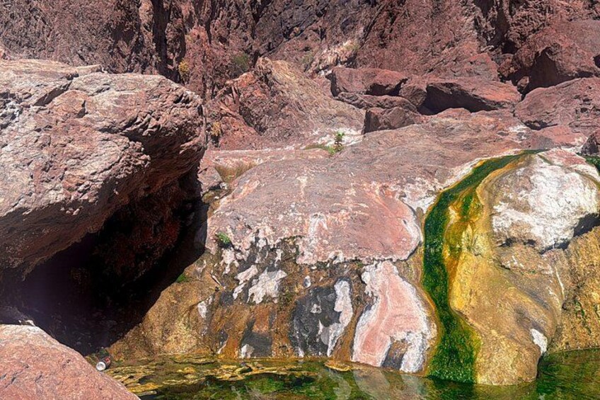 A rocky landscape with a river flowing through it. 4