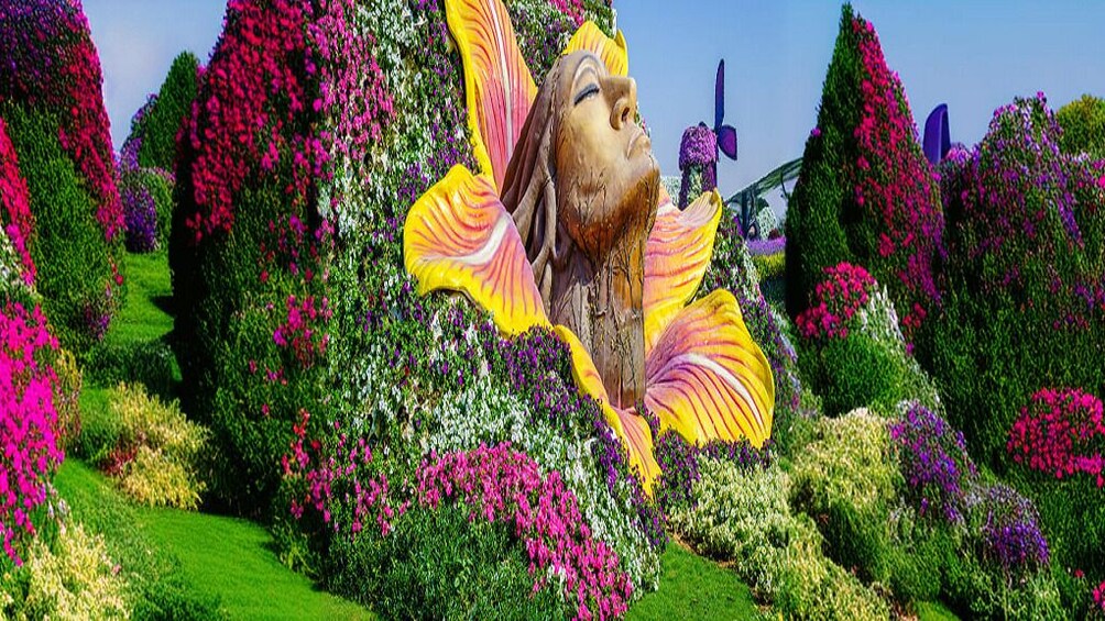 A garden with a large floral sculpture and various colorful flowers. 5