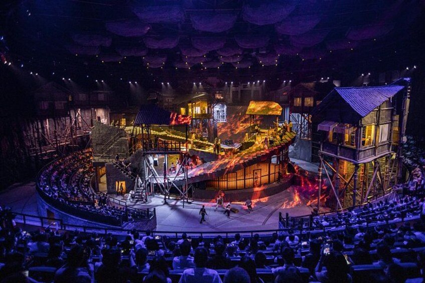 A theater with a stage, audience seating, and a fire effect. 2