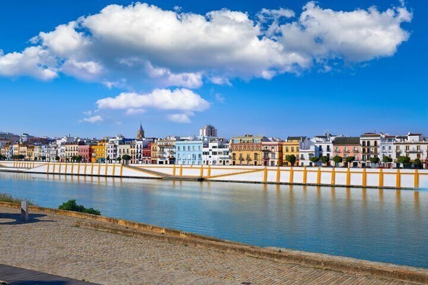 A waterfront with colorful buildings and a clear blue sky. 2