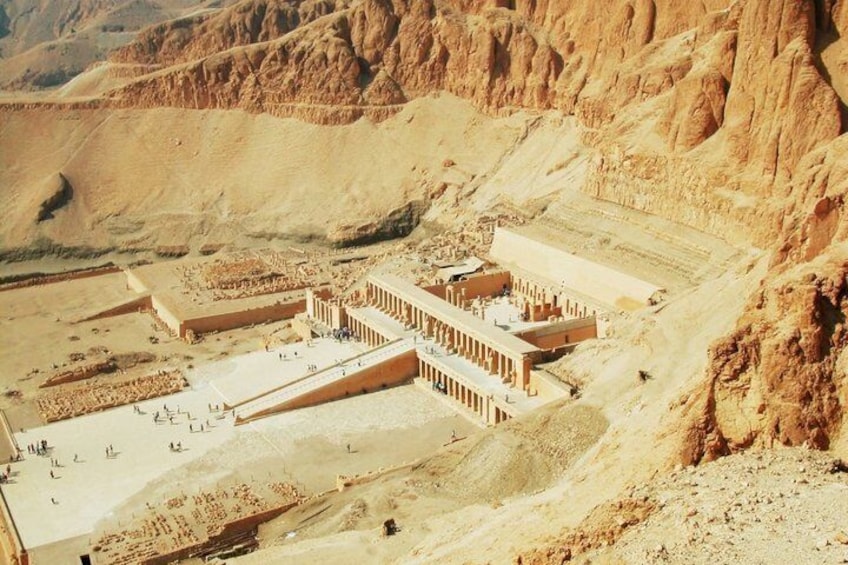 A large ancient Egyptian temple complex with multiple structures and a surrounding desert landscape. 4