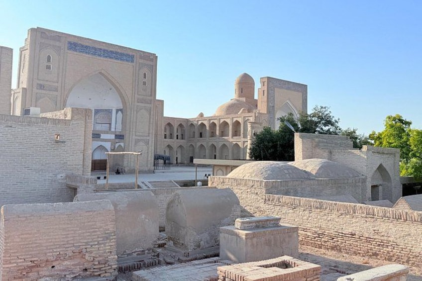 An ancient building with arched windows and domed structures. 2
