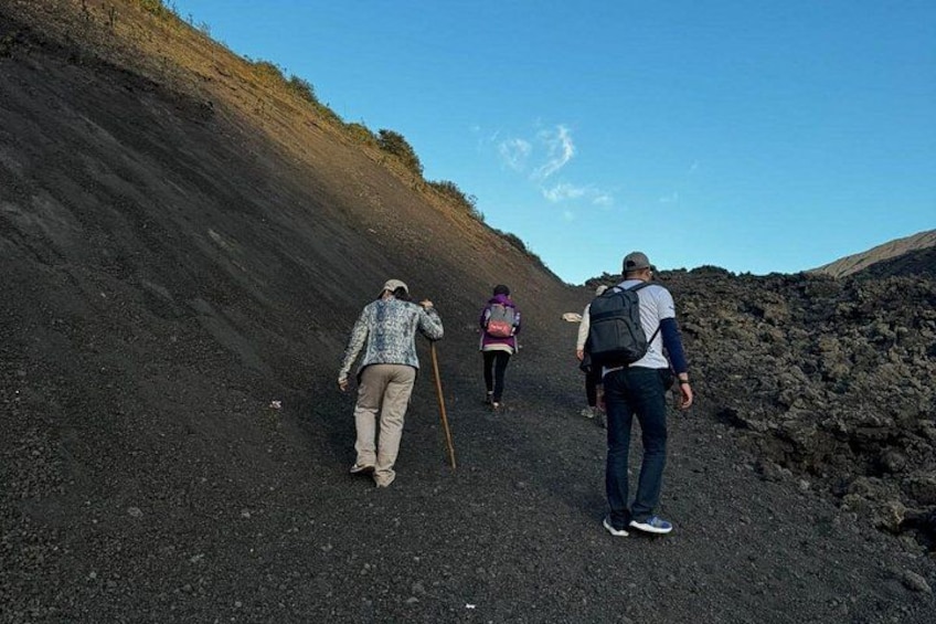 Three people hiking on a rocky path with a steep incline. 5