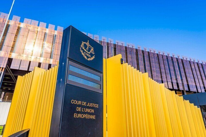 The entrance to the Court of Justice of the European Union with a modern building and yellow barriers. 5