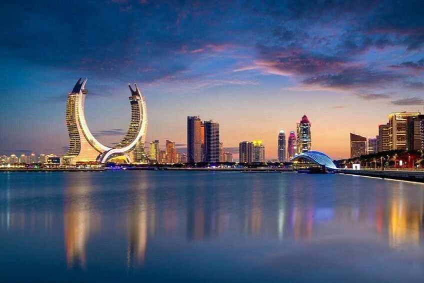 A city skyline with modern architecture, including a distinctive curved building and a bridge. 5