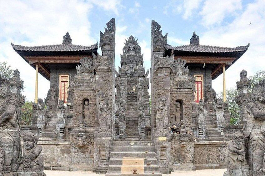 A temple with intricate carvings and a traditional roof structure. 3