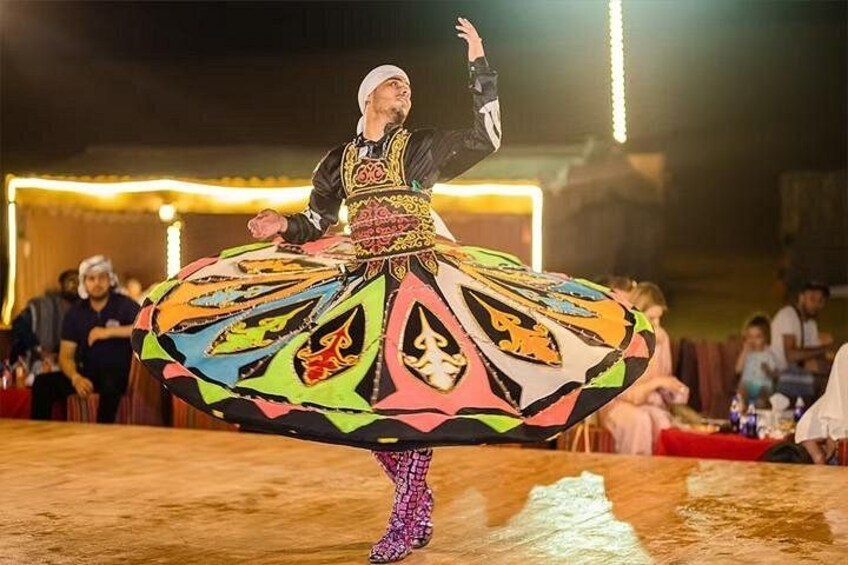 A person performing a dance with a colorful, patterned costume. 2