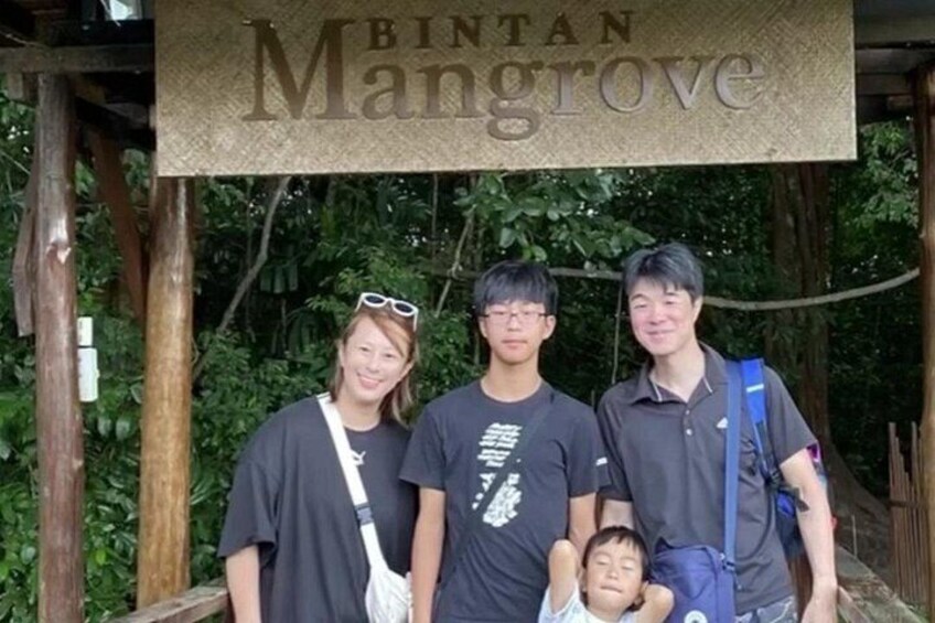 A group of people standing in front of a sign that reads 'BINTAN Mangrove.' 3