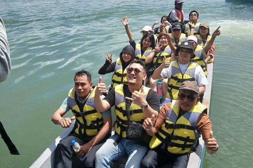 A group of people on a boat wearing life jackets. 4