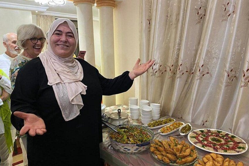 A person standing in front of a buffet table with various dishes. 1