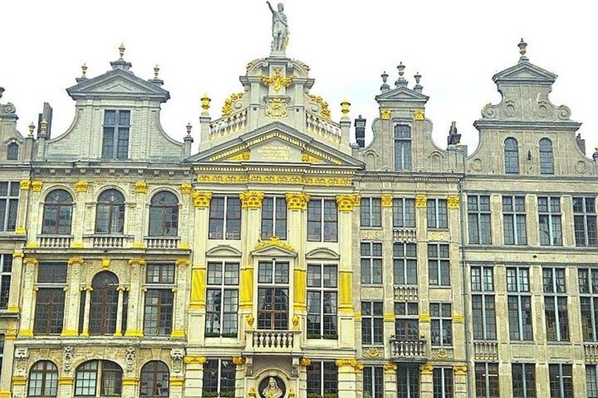 A large, ornate building with multiple windows and statues. 3