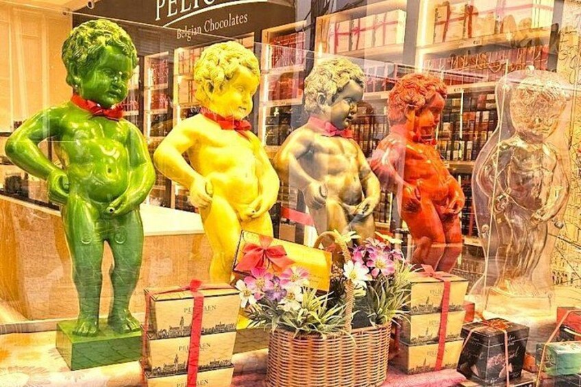 A chocolate shop display with colorful chocolate figures and a basket of flowers. 5