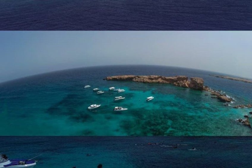 A turquoise sea with boats and a rocky outcrop. 3