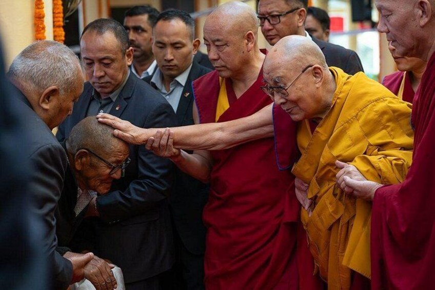 A group of people in a formal setting, some wearing traditional robes, others in suits. 3