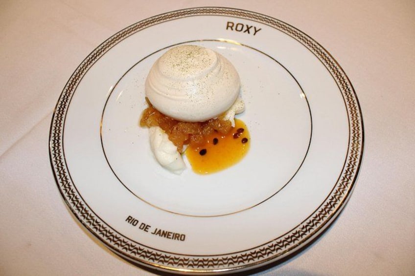 A dessert plate with a meringue, caramel sauce, and a scoop of ice cream. 5