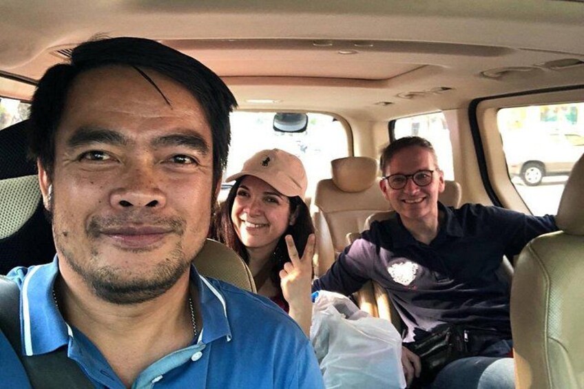 A vehicle interior with three people seated. 4