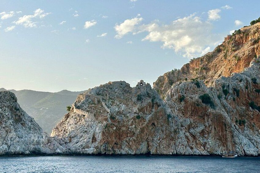 A rocky coastline with cliffs and a body of water. 4