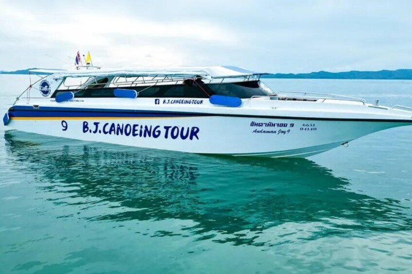 A boat named 'B.J. Canoeing Tour' with the number 9 on its side, floating on calm water with a clear sky in the background. 2