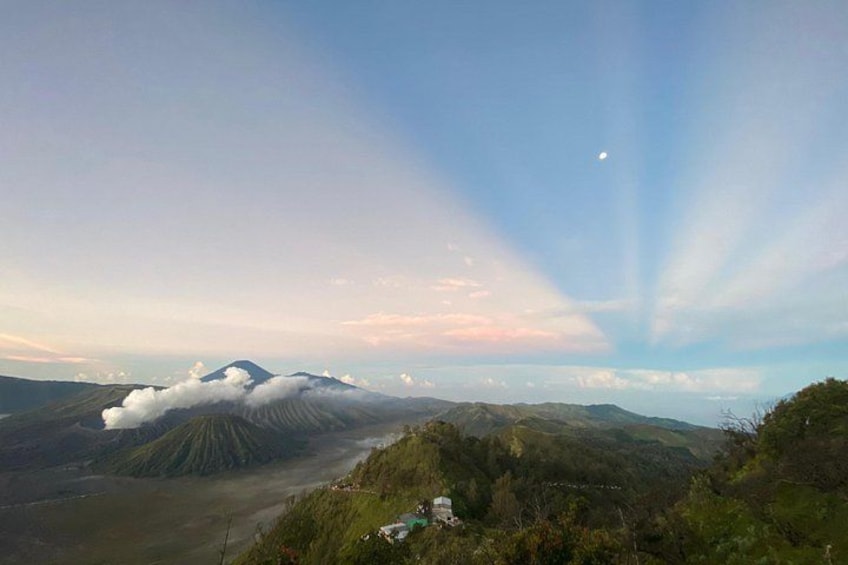 A mountain landscape with a visible cloud formation and a clear sky. 3