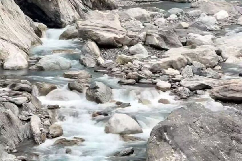 A rocky stream with flowing water. 5