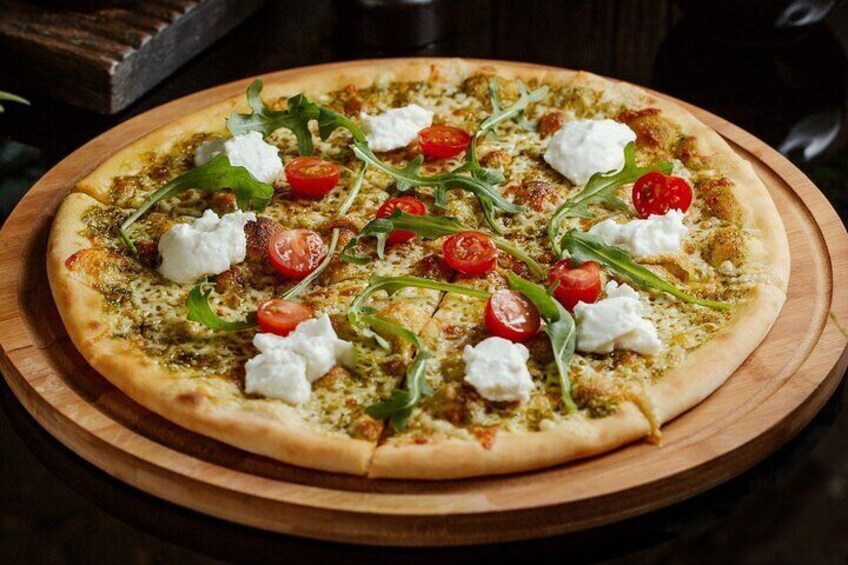 A pizza with toppings on a wooden board. 3