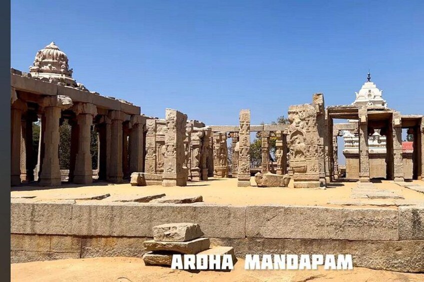 Ancient stone ruins with columns and a temple structure. 1
