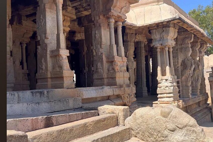 Ancient stone architecture with detailed carvings and steps leading into a structure. 2