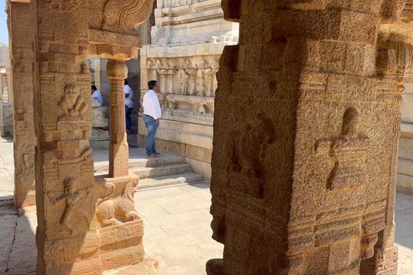 Ancient stone carvings, a stone pillar, and a person in the background. 3