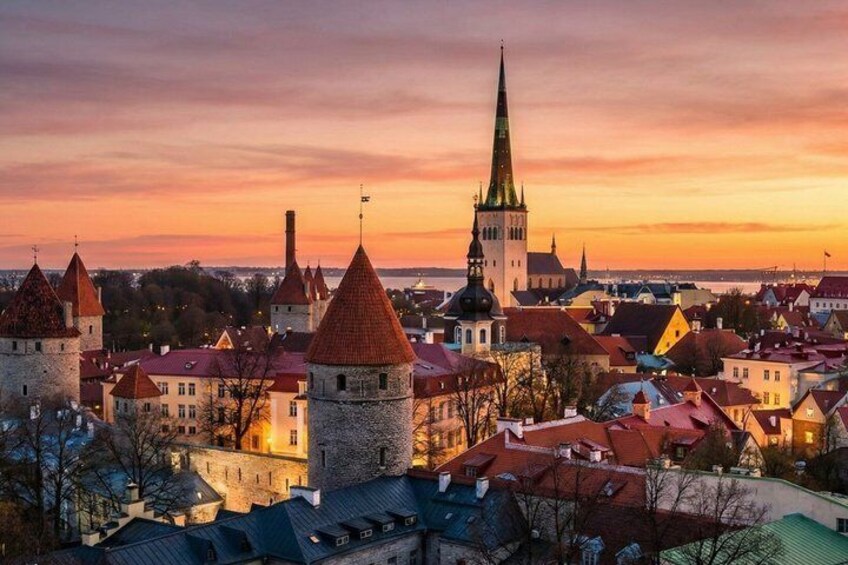 A historic town with medieval architecture, including towers and a church with a tall spire. 1