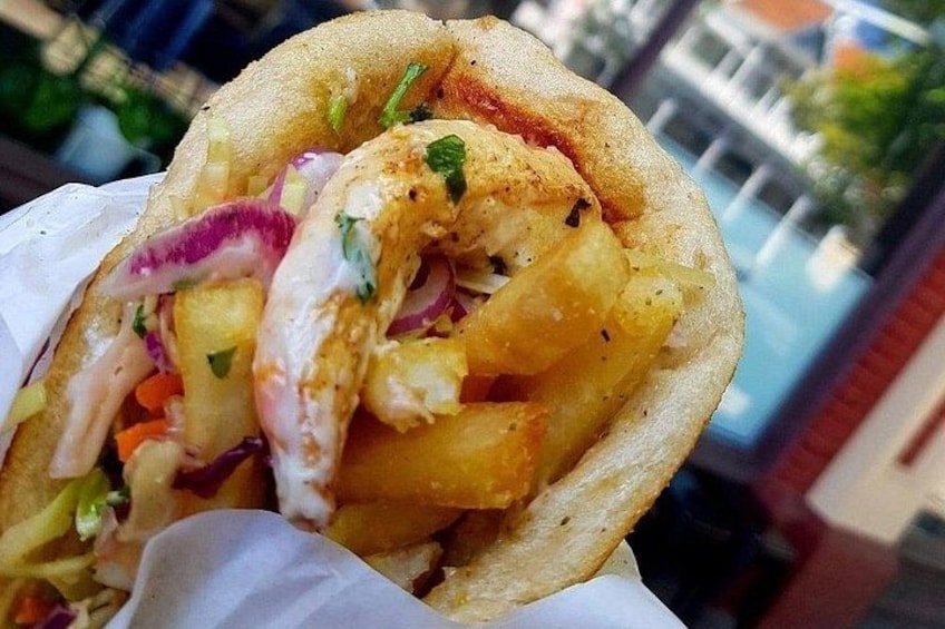 A wrap with shrimp, potatoes, and vegetables. 5