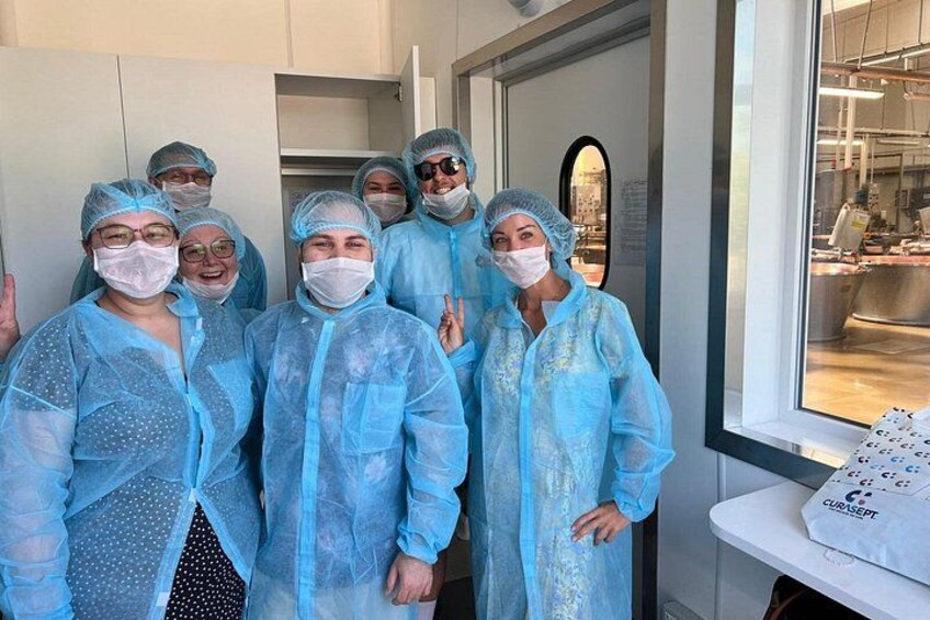 A group of people in protective clothing, likely in a medical or laboratory setting. 1