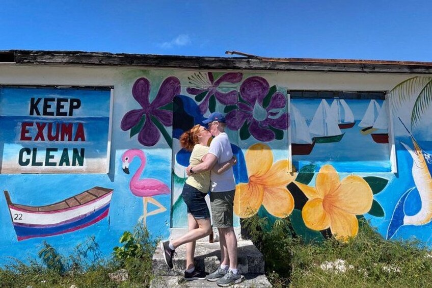 A mural with a boat, flamingo, and flowers. 3
