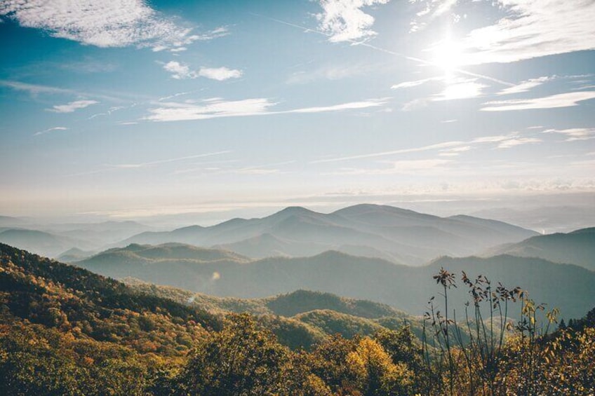 A mountainous landscape with rolling hills and a clear sky. 1