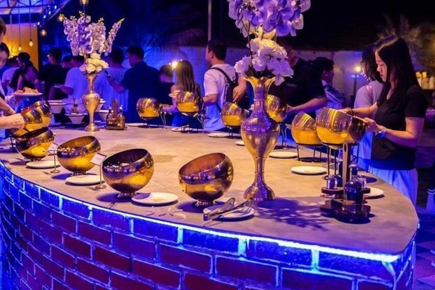 A bar with golden bowls and a vase of flowers. 4