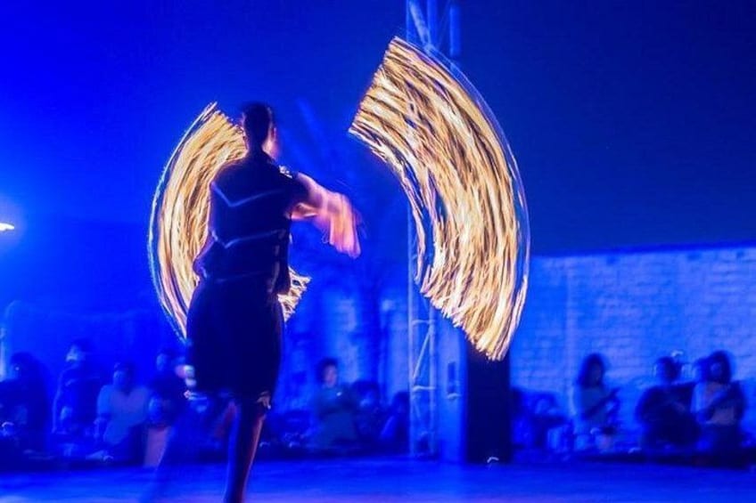A person performing fire spinning with a blurred light trail. 3