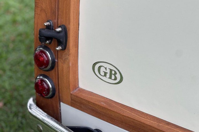 A vehicle with a GB logo and a wooden trim detail. 5