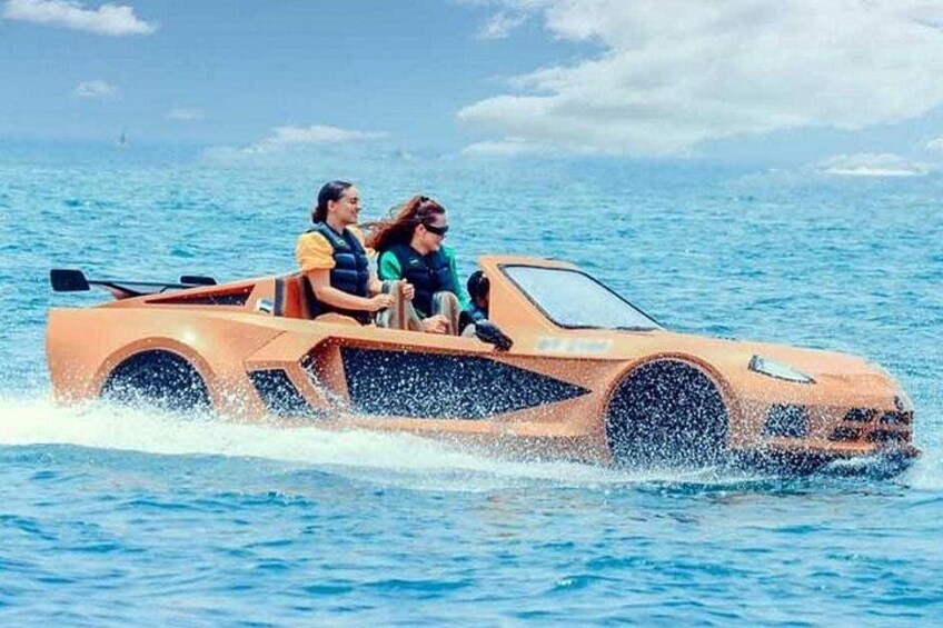 A vehicle on water, two people in it, and a clear sky. 3