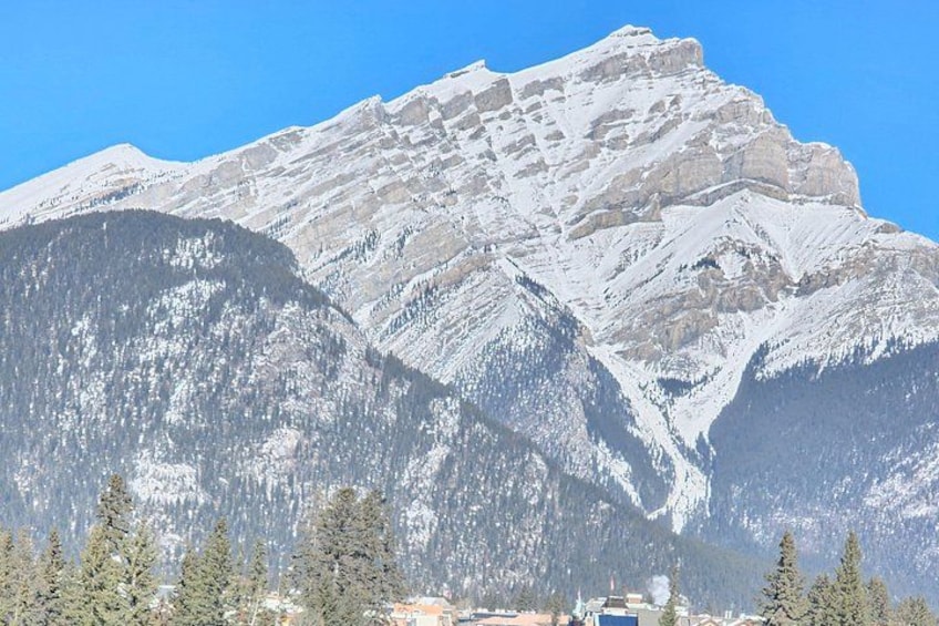 A snow-covered mountain with a clear blue sky. 5