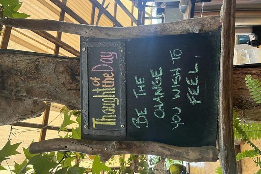 A chalkboard sign with motivational writing. 2