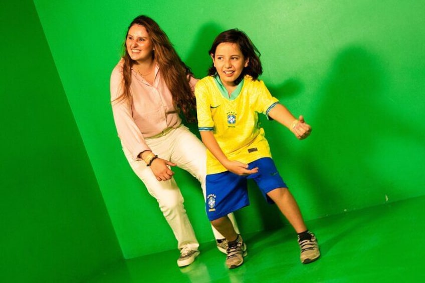 Two people against a green background. 2