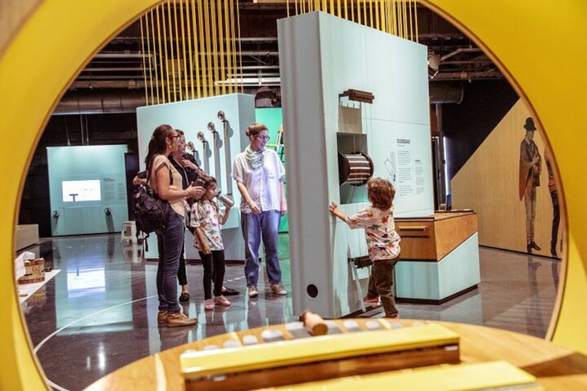 A museum exhibit with a child interacting with a display. 3