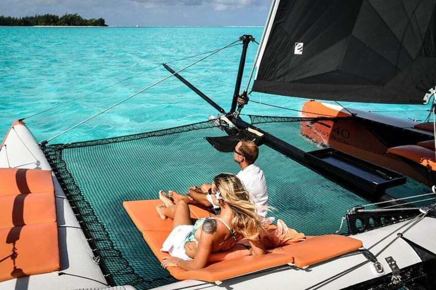 A sailboat with two people relaxing on the deck. 5