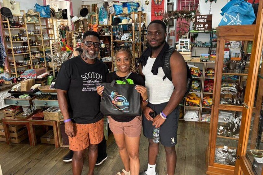 Three people in a store with shelves of various items. 2