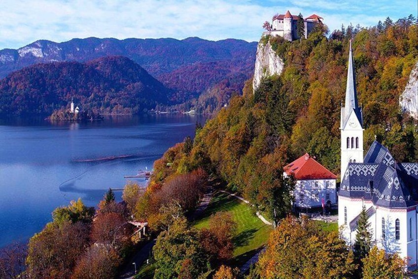 A castle on a hill, a church, and a lake. 4