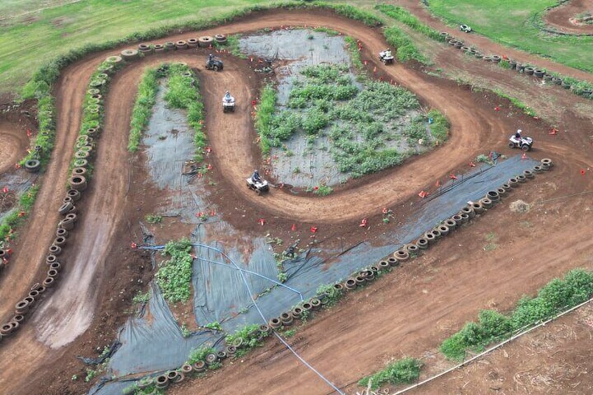 A motocross track with tire barriers and riders. 3